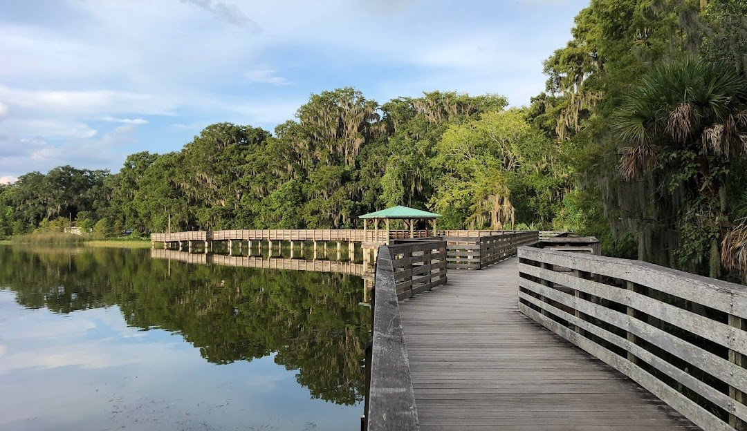 bridge on the water with a gazebo and trees